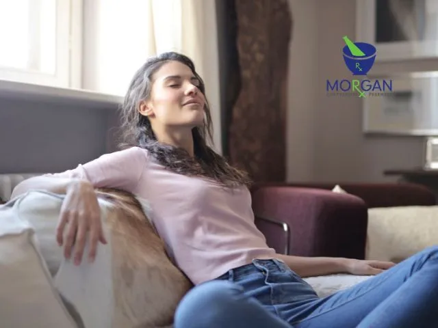 Woman Resting on a Sofa with Eyes Closed